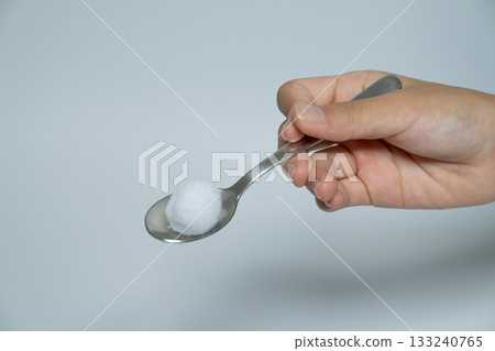 Spoon and cotton balls 133240765