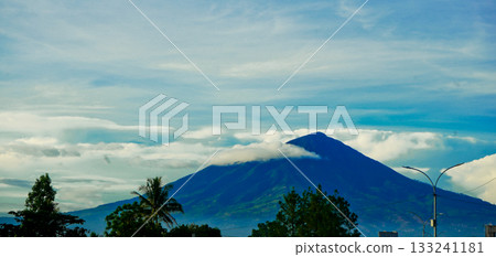 beautiful view of mountains with white clouds and clear blue sky in the background beautiful view of mountains with white clouds and clear blue sky in the background 133241181
