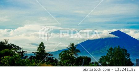 beautiful view of mountains with white clouds and clear blue sky in the background beautiful view of mountains with white clouds and clear blue sky in the background 133241182