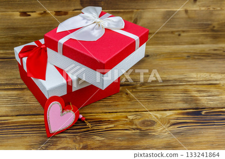 Gift boxes and red heart on a wooden background. Valentine's Day concept 133241864