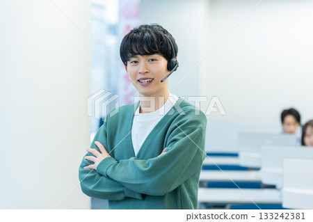 Young male operator speaking on intercom 133242381