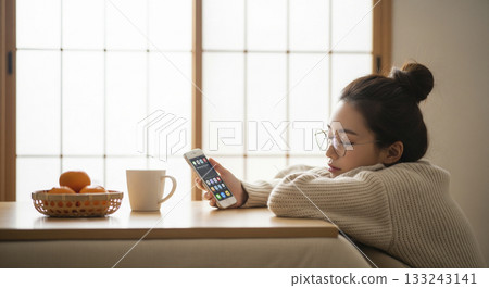 Japanese woman taking a nap in a kotatsu Japanese woman taking a nap in a kotatsu 133243141