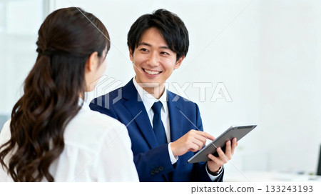 A male customer support staff member serving customers 133243193
