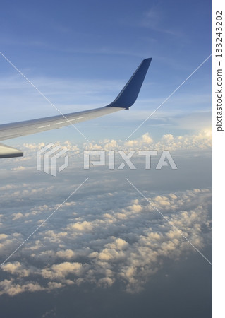Sea of clouds and wings seen from the plane 133243202