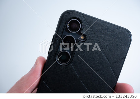 Smartphone in Black Leather Case in Hand Smartphone in Black Leather Case in Hand 133243356