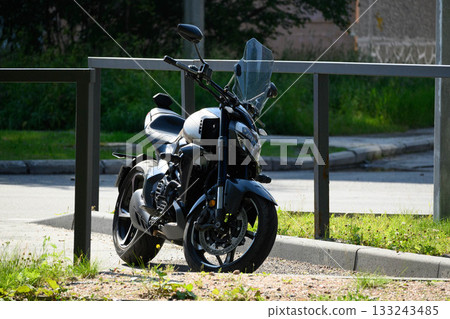 Lone Motorcycle in an Urban Parking Lot Lone Motorcycle in an Urban Parking Lot 133243485