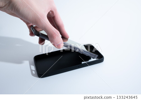 Smartphone Without Case Next to Black Cover Smartphone Without Case Next to Black Cover 133243645