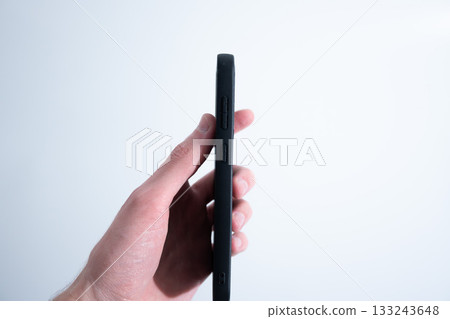 Smartphone in Black Leather Case in Hand Smartphone in Black Leather Case in Hand 133243648