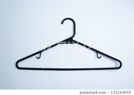 Black Plastic Clothes Hanger on White Background 133243650