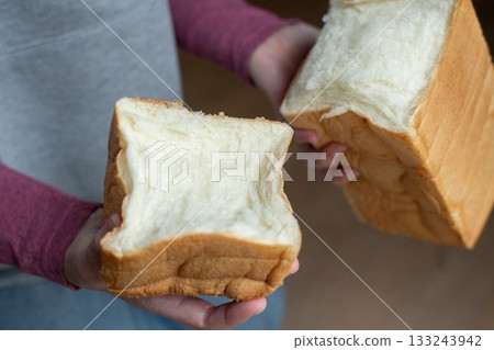 A person holding soft bread A person holding soft bread 133243942