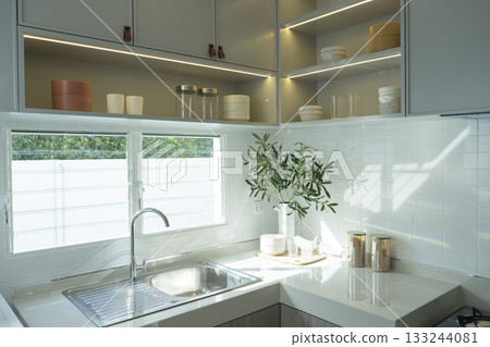 modern kitchen with white ceramic tiles and white worktop 133244081