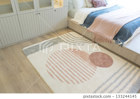 close up view of modern and beautiful graphic pattern carpet in bedroom. close up view of modern and beautiful graphic pattern carpet in bedroom. 133244145