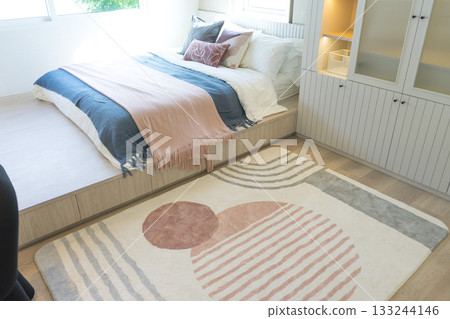 close up view of modern and beautiful graphic pattern carpet in bedroom. 133244146