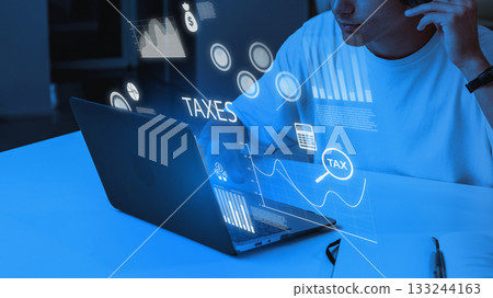 Working on tax preparation with digital tools at a modern desk Working on tax preparation with digital tools at a modern desk 133244163