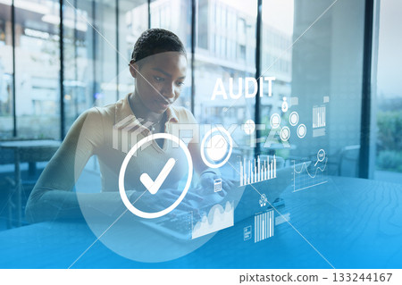 Professional conducting an audit using a digital device in a modern office setting Professional conducting an audit using a digital device in a modern office setting 133244167
