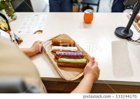 Delicious desserts served on a wooden tray at a cozy pastry shop in the afternoon Delicious desserts served on a wooden tray at a cozy pastry shop in the afternoon 133244170