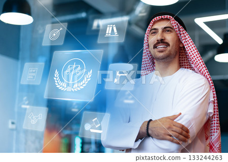 Professional man in traditional attire interacting with digital law symbols Professional man in traditional attire interacting with digital law symbols 133244263