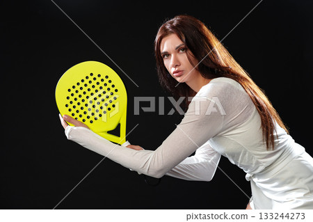 Young woman practicing with a paddle in a sporty and intense moment Young woman practicing with a paddle in a sporty and intense moment 133244273