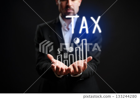 Businessman holding graphs and tax symbols in a creative presentation 133244280