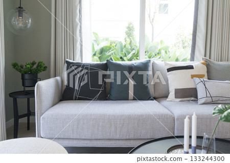 large contemporary designer sofa with side table and modern pillow. 133244300