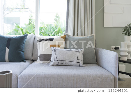 large contemporary designer sofa with side table and modern pillow. 133244301