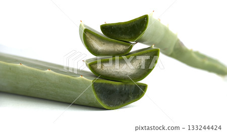 Aloe vera slices displayed, revealing the inner gel and its fresh, green leaves. Aloe vera slices displayed, revealing the inner gel and its fresh, green leaves. 133244424