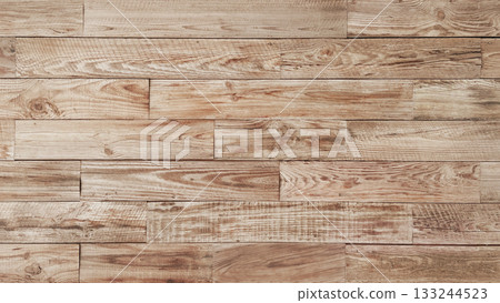 Horizontal background image of an aged plank wall of light brown rough-sawn lumber with wood grain Horizontal background image of an aged plank wall of light brown rough-sawn lumber with wood grain 133244523
