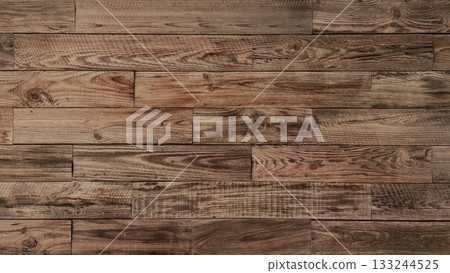 Horizontal background image of an aged plank wall of brown rough-sawn lumber with wood grain Horizontal background image of an aged plank wall of brown rough-sawn lumber with wood grain 133244525