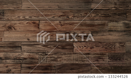 A horizontal background image of an old plank wall of brown, rough-sawn lumber with grain 133244526