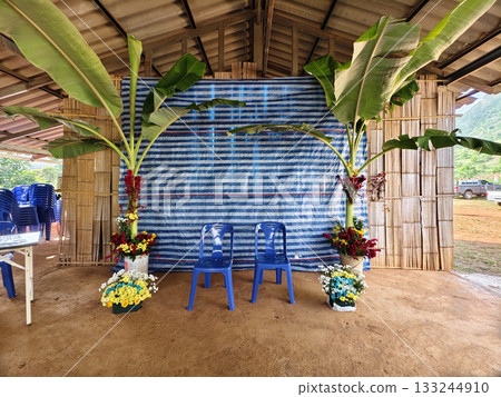 Simple and beautiful traditional Lahu wedding setup in northern Thailand, decorated with banana trees and colorful flowers. Simple and beautiful traditional Lahu wedding setup in northern Thailand, decorated with banana trees and colorful flowers. 133244910