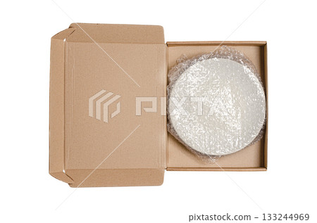 An open cardboard box with bubble wrap. The concept of packaging parcels with fragile cargo. Isolated on white 133244969