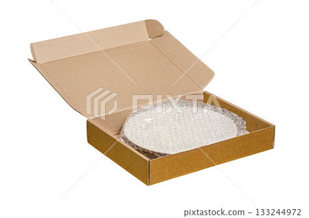An open cardboard box with bubble wrap. The concept of packaging parcels with fragile cargo. Isolated on white An open cardboard box with bubble wrap. The concept of packaging parcels with fragile cargo. Isolated on white 133244972