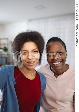 Happy mother and daughter taking selfie at home 133245321