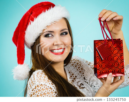 Happy Christmas woman holds gift bag 133245750