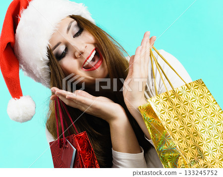 Happy Christmas woman holds gifts bag Happy Christmas woman holds gifts bag 133245752