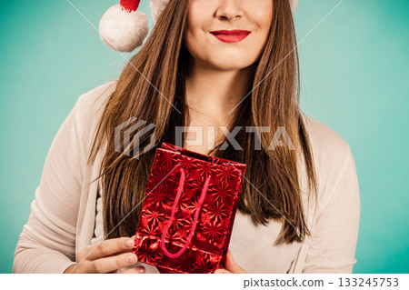 Happy Christmas woman holds red gift bag Happy Christmas woman holds red gift bag 133245753