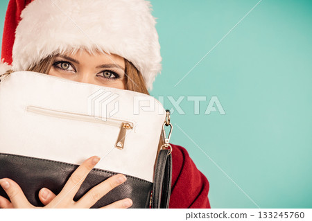Christmas girl holding handbag present Christmas girl holding handbag present 133245760