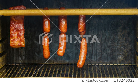 Smoked sausages meat hanging in smokehouse 133246022