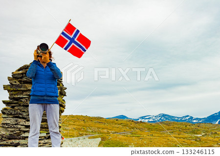Tourist with camera in Norway mountains Tourist with camera in Norway mountains 133246115
