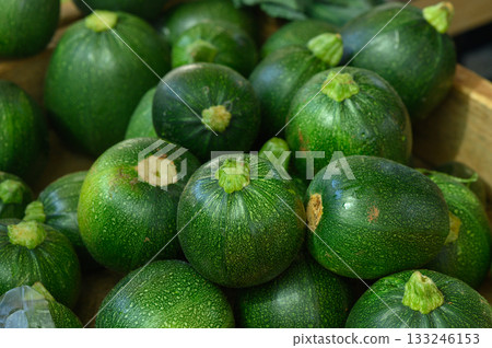 Fresh green zucchinis arranged beautifully at a local farmers market in autumn Fresh green zucchinis arranged beautifully at a local farmers market in autumn 133246153