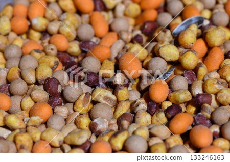 Colorful blend of seeds and grains creating a vibrant natural display for wildlife feeding Colorful blend of seeds and grains creating a vibrant natural display for wildlife feeding 133246163