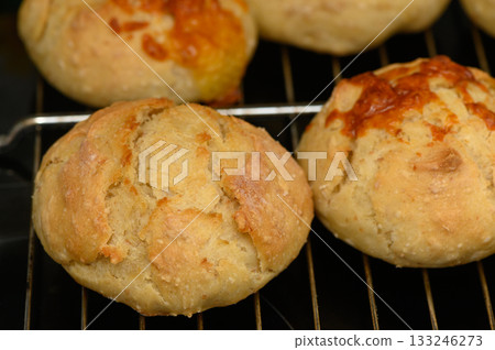 Freshly baked rolls showing golden crusts in a cozy kitchen during a sunny afternoon 133246273