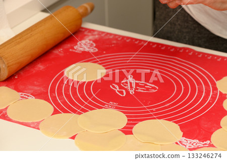 Rolling out dough for delicious treats in a bright and cozy kitchen space filled with warmth and creativity Rolling out dough for delicious treats in a bright and cozy kitchen space filled with warmth and creativity 133246274
