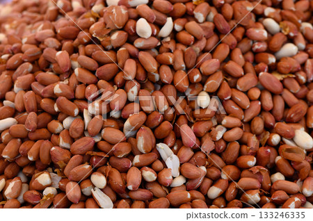 Pile of fresh raw peanuts ready for culinary adventures at a vibrant market 133246335