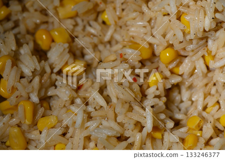 Savory rice dish mixed with sweet corn offering a burst of flavor in a simple yet delightful meal Savory rice dish mixed with sweet corn offering a burst of flavor in a simple yet delightful meal 133246377