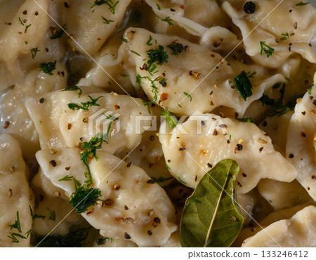 Enjoying a warm bowl of homemade dumplings with herbs and spices on a cozy afternoon 133246412