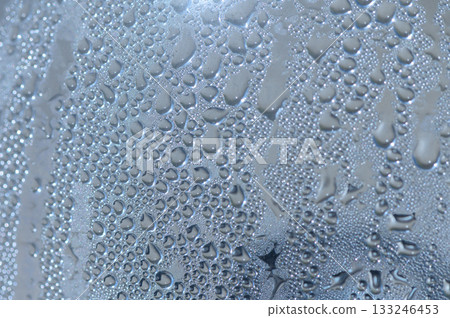 Water droplets cling to a surface after a refreshing rainfall illuminating delicate patterns 133246453