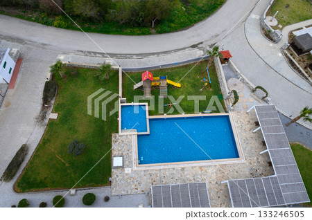 Colorful playground with a sparkling pool in a serene landscape 133246505