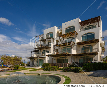 Elegant beachfront architecture with modern villas under a clear blue sky 133246531