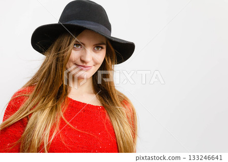 Positive pretty girl with brown hair and black hat. 133246641